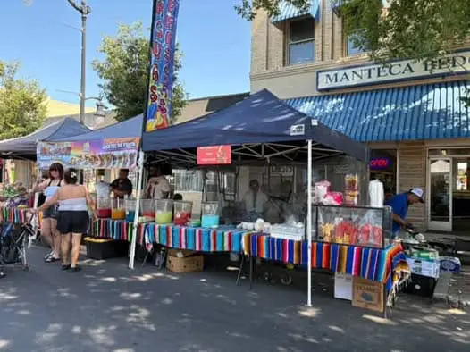 A festival street filled with vendor tents.